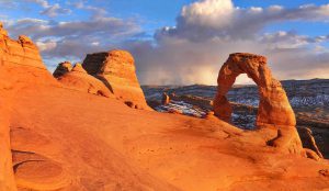 The arches in Utah with clouds in the distance